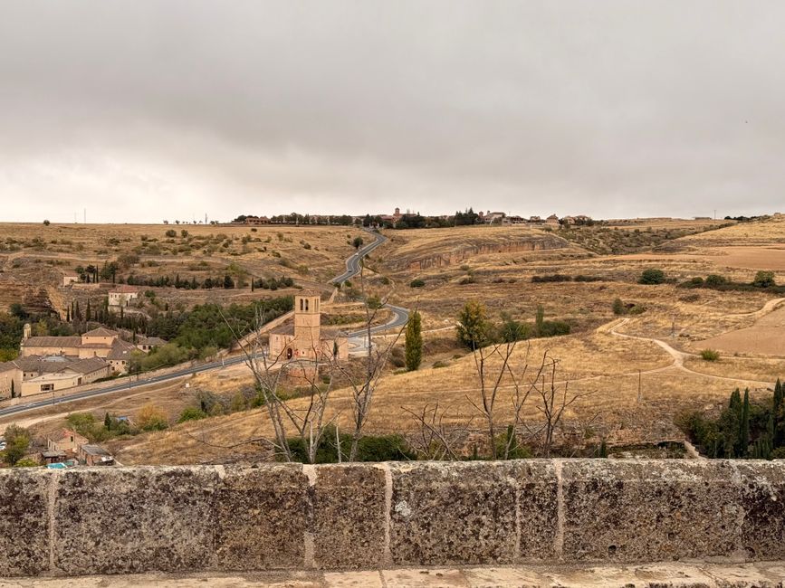pexels photo 34706974 Scenic view of Segovia's rolling fields and historic architecture under a cloudy sky.